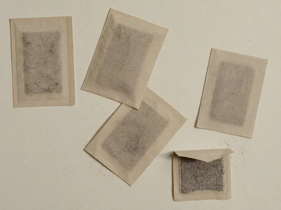 Disposable chemical hand-warmer sachets, one torn open